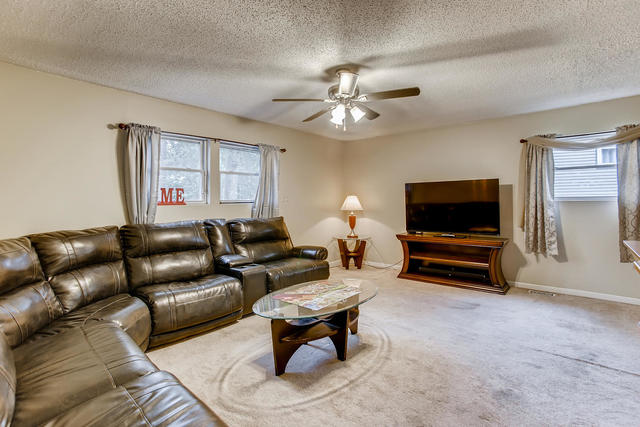 145 South Pinecrest Road Bolingbrook, IL 60440 - Photo 2 of 17 a living room with furniture a flat screen tv and a window