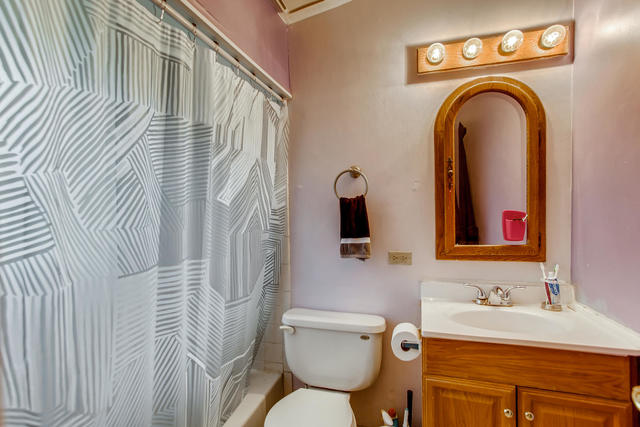 145 South Pinecrest Road Bolingbrook, IL 60440 - Photo 12 of 17 a bathroom with a toilet sink vanity and mirror