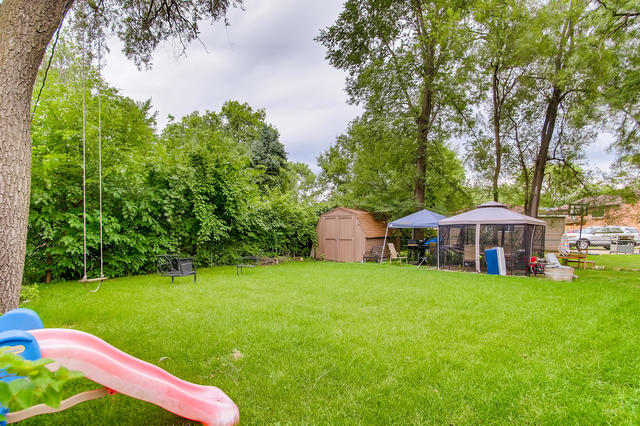 145 South Pinecrest Road Bolingbrook, IL 60440 - Photo 17 of 17 a view of a house with a yard porch and sitting area