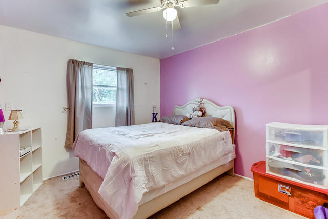 145 South Pinecrest Road Bolingbrook, IL 60440 - Photo 6 of 17 a bedroom with a bed and a chandelier
