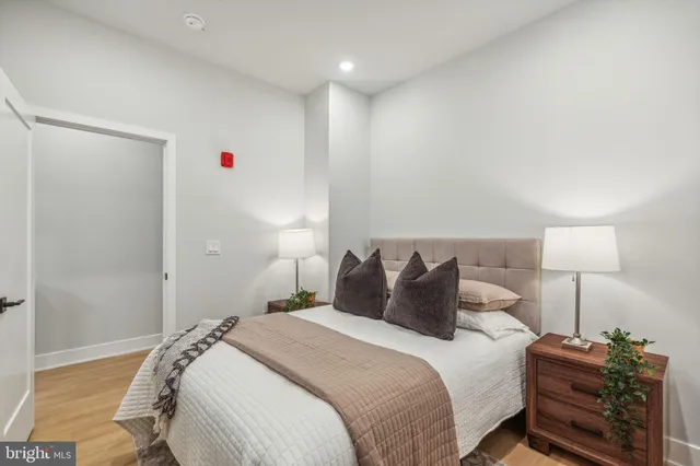 a bedroom with a bed and a night stand