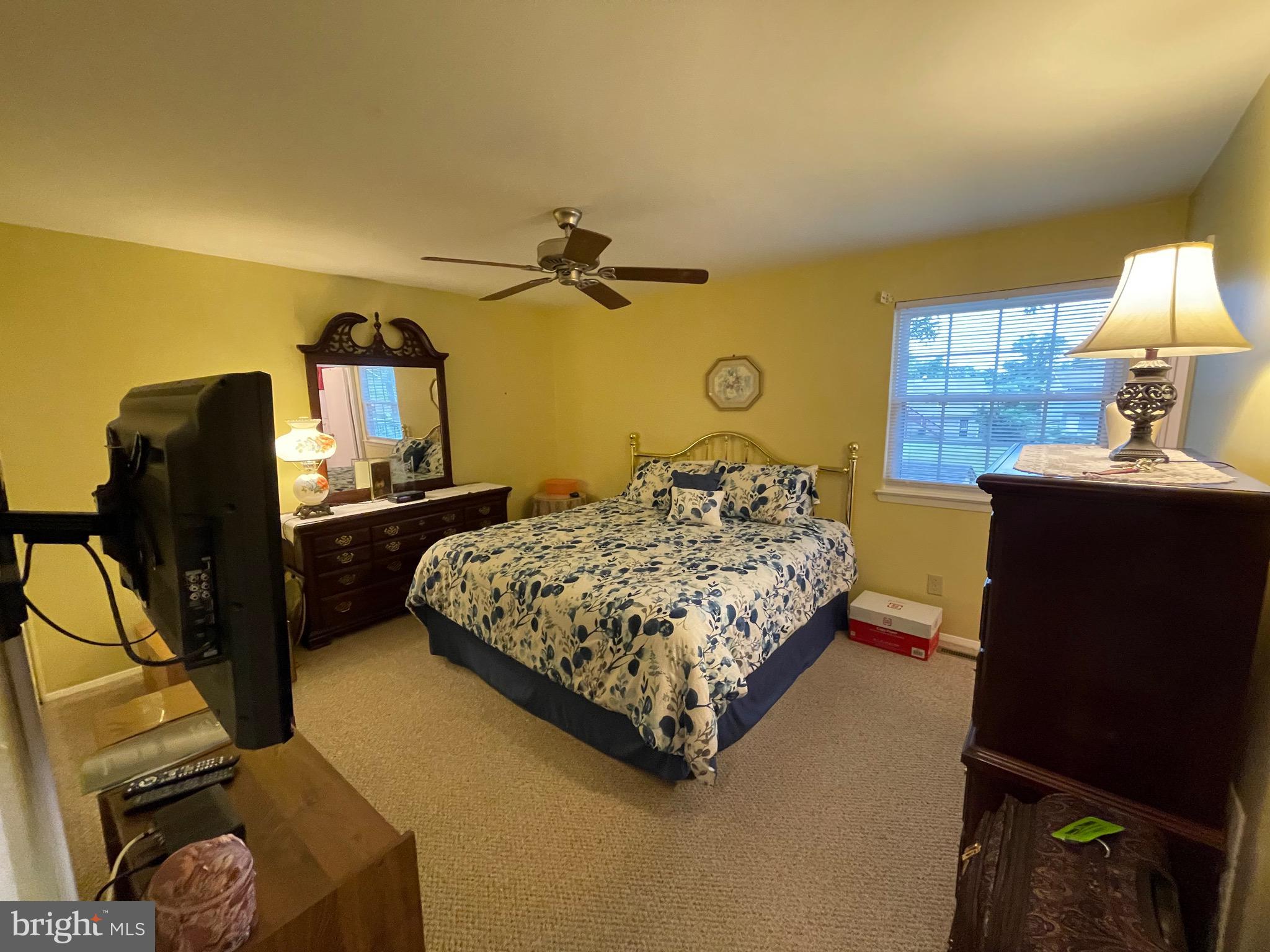 4010 Winlee Road Randallstown, MD 21133 - Photo 20 of 41 a bedroom with a bed dresser and a flat tv screen on a dresser