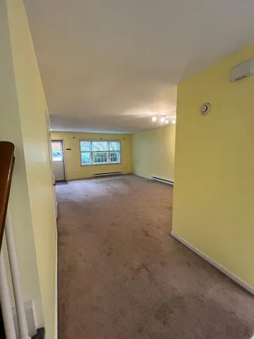 a view of an empty room with a window