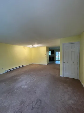 a view of an empty room with a fireplace