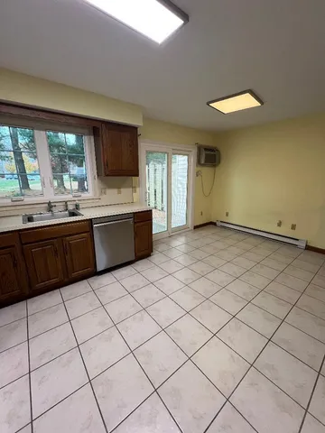 a large kitchen with a sink and cabinets