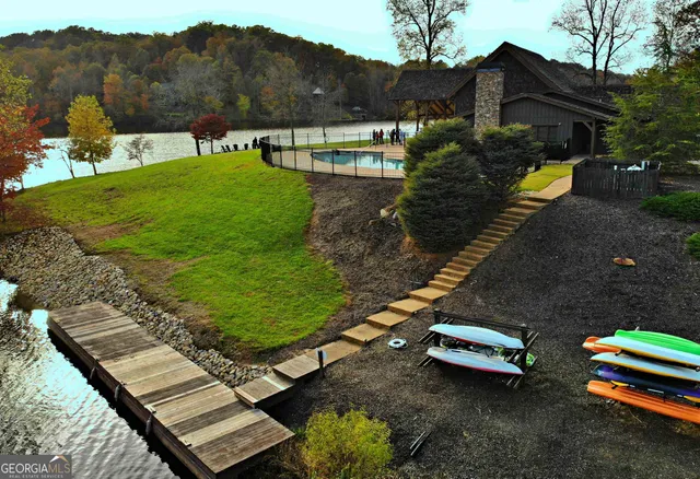an aerial view of a house with swimming pool patio and outdoor seating