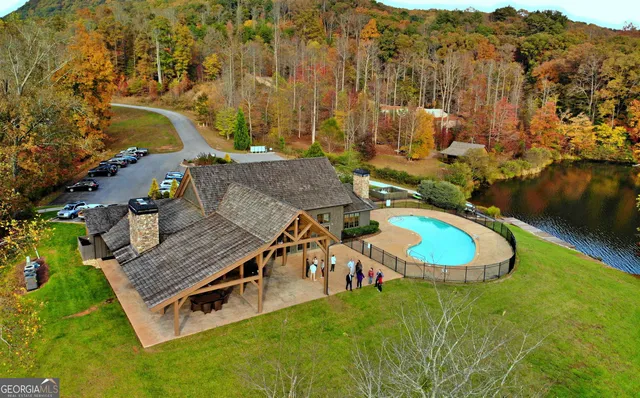 an aerial view of a house with a garden and lake view