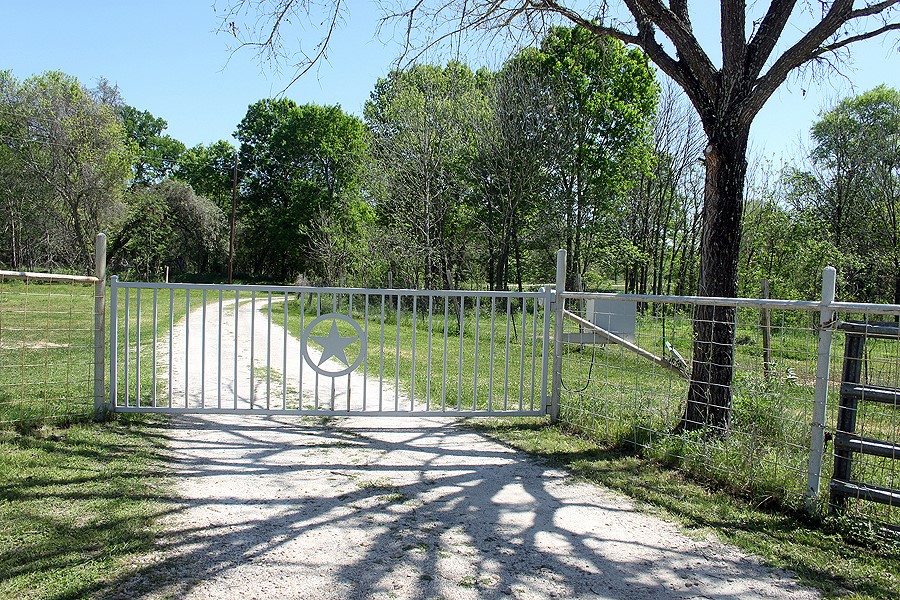 146 Bugtussle Lane Luling, TX 78648 - Photo 1 of 1 a view of a lake with a large trees