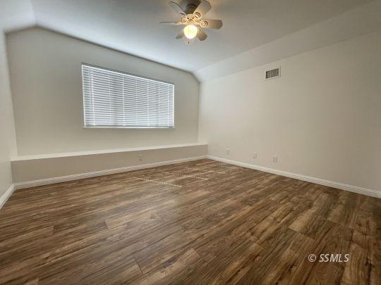 656 West Felspar Avenue Ridgecrest, CA 93555 - Photo 28 of 45 a view of a room with wooden floor and a ceiling fan