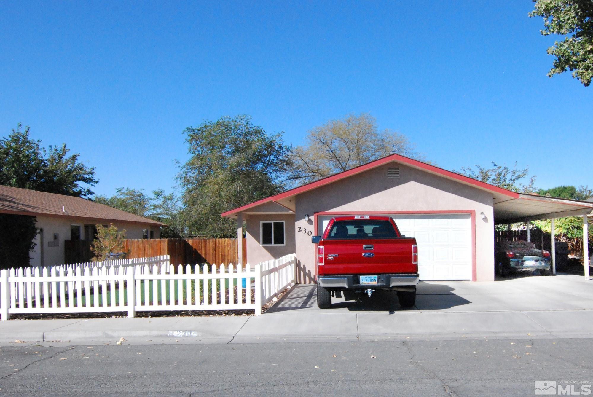 230 Whitaker Lane Fallon, NV 89406 - Photo 1 of 23 a view of a house with a small yard and wooden fence