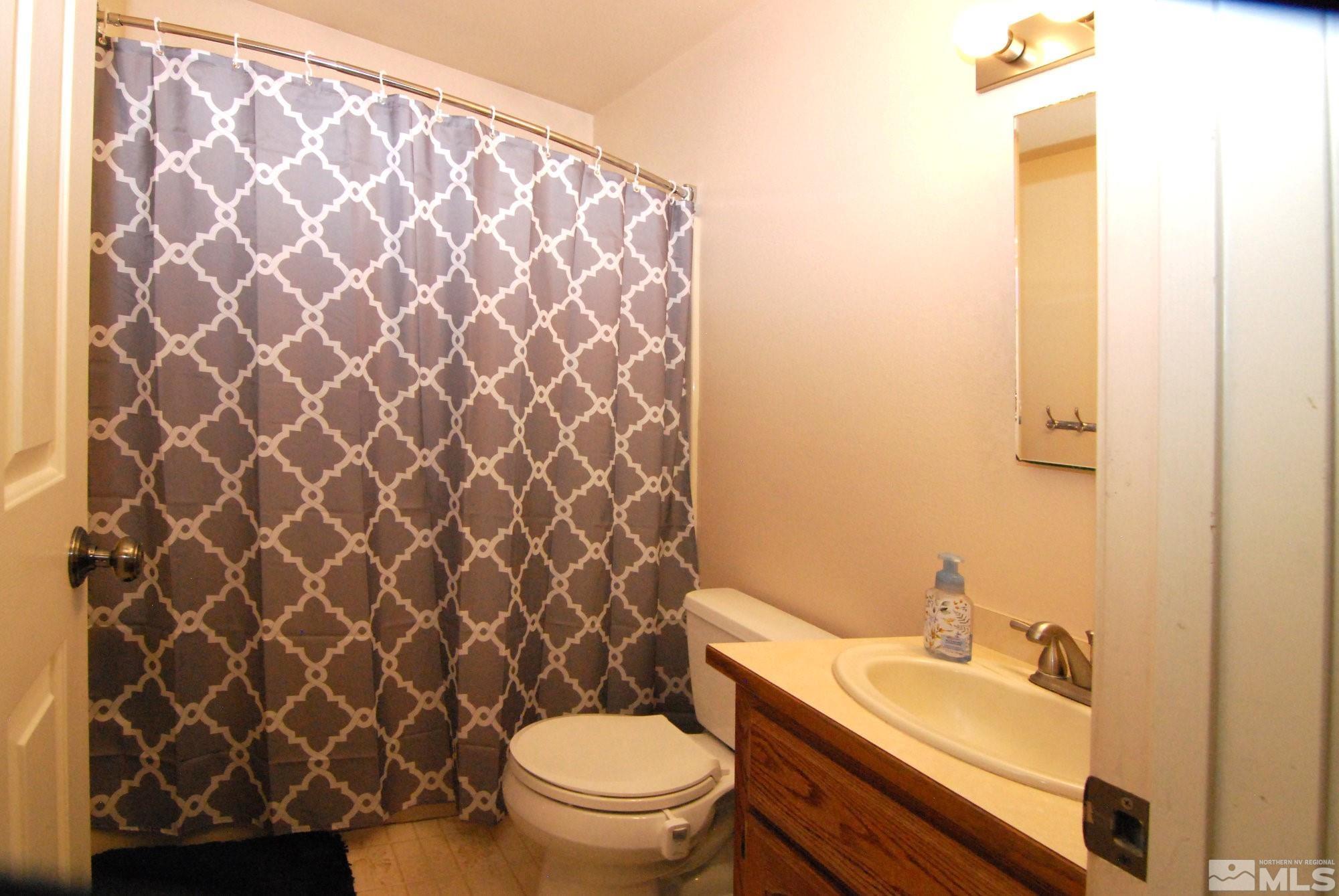 230 Whitaker Lane Fallon, NV 89406 - Photo 14 of 23 a bathroom with a toilet and a sink
