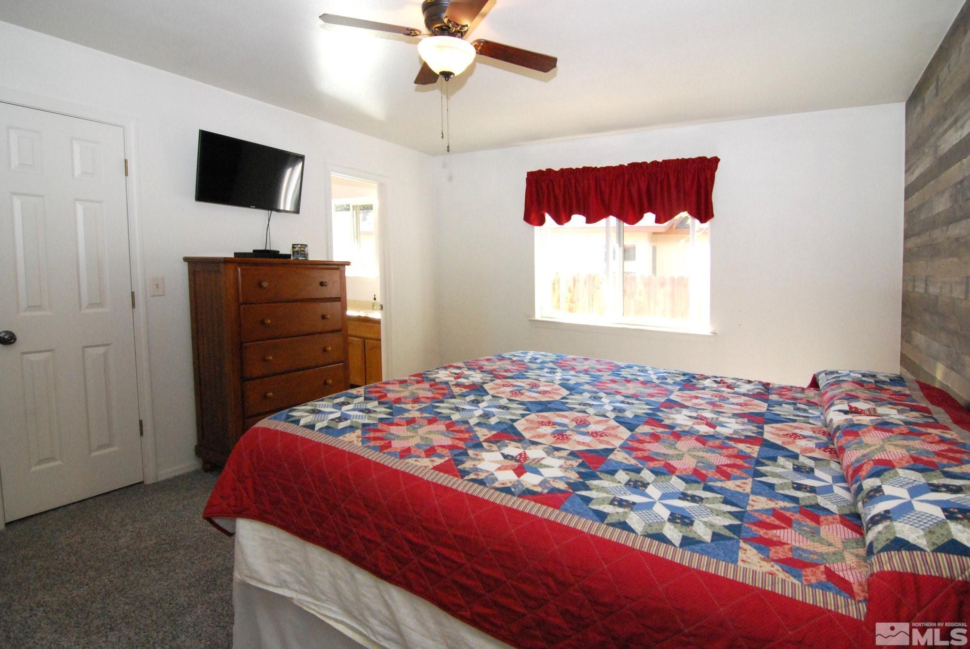 230 Whitaker Lane Fallon, NV 89406 - Photo 15 of 23 a bedroom with a bed and a flat screen tv