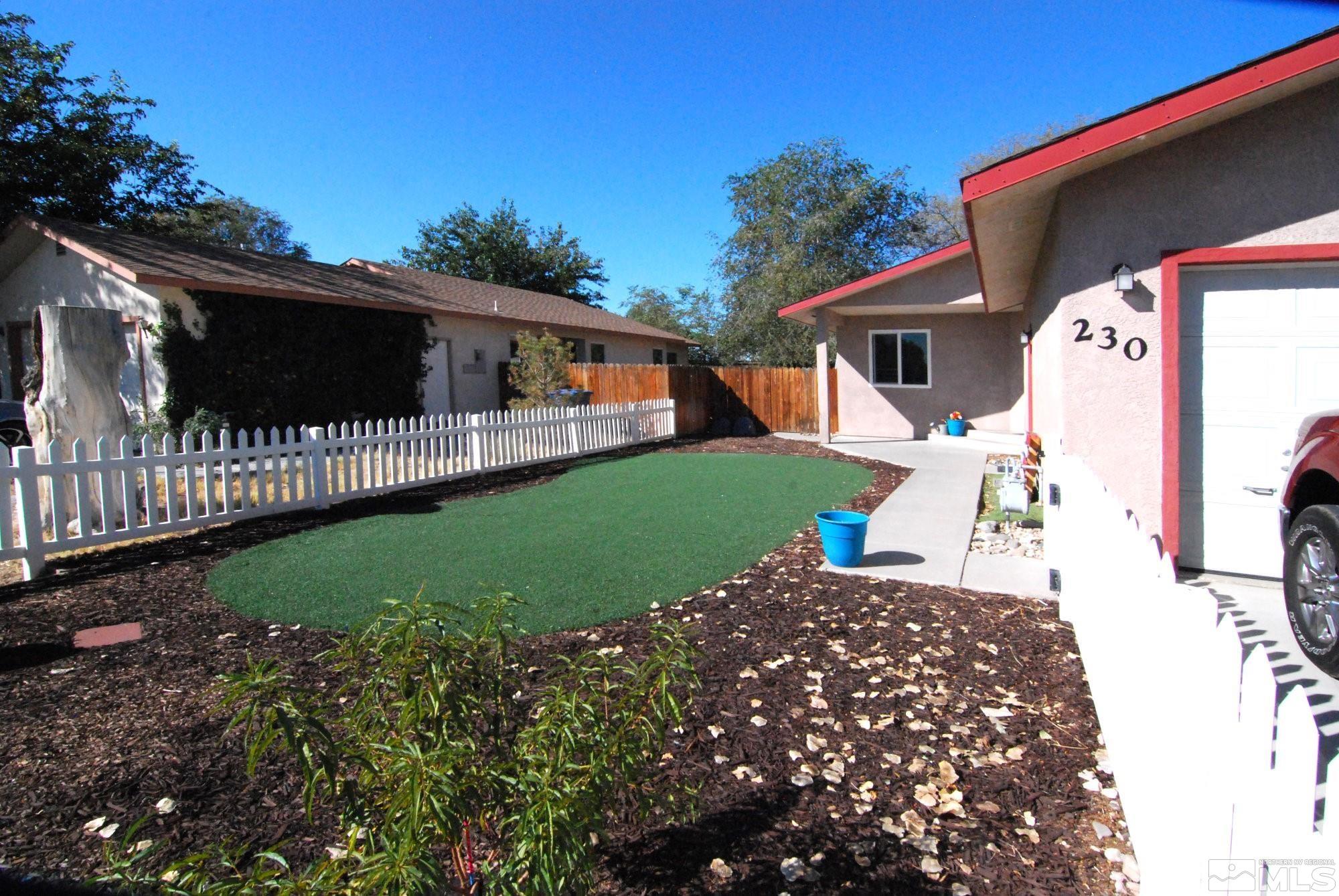 230 Whitaker Lane Fallon, NV 89406 - Photo 2 of 23 a view of a backyard with a garden