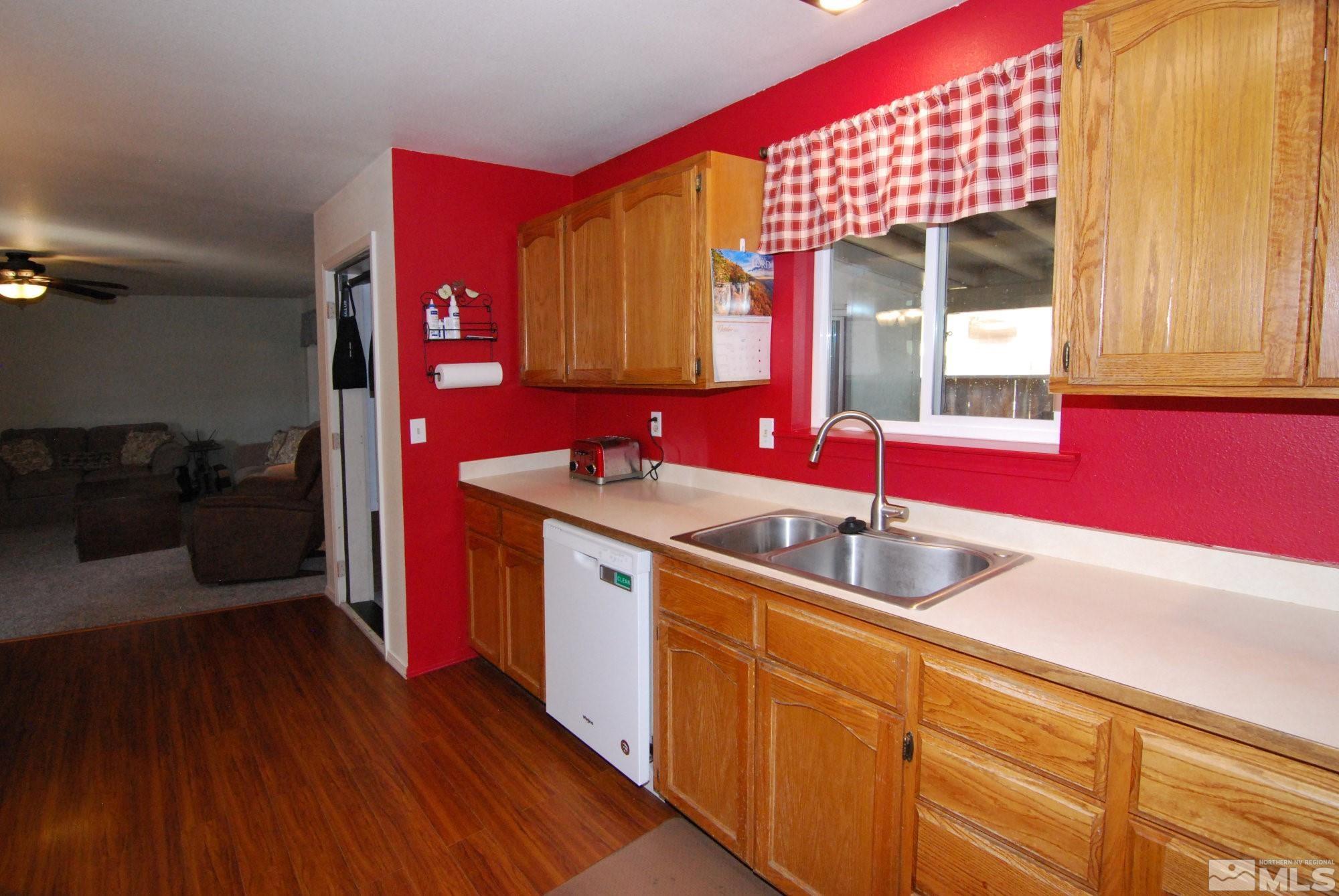 230 Whitaker Lane Fallon, NV 89406 - Photo 5 of 23 a kitchen with granite countertop a sink and wooden cabinets