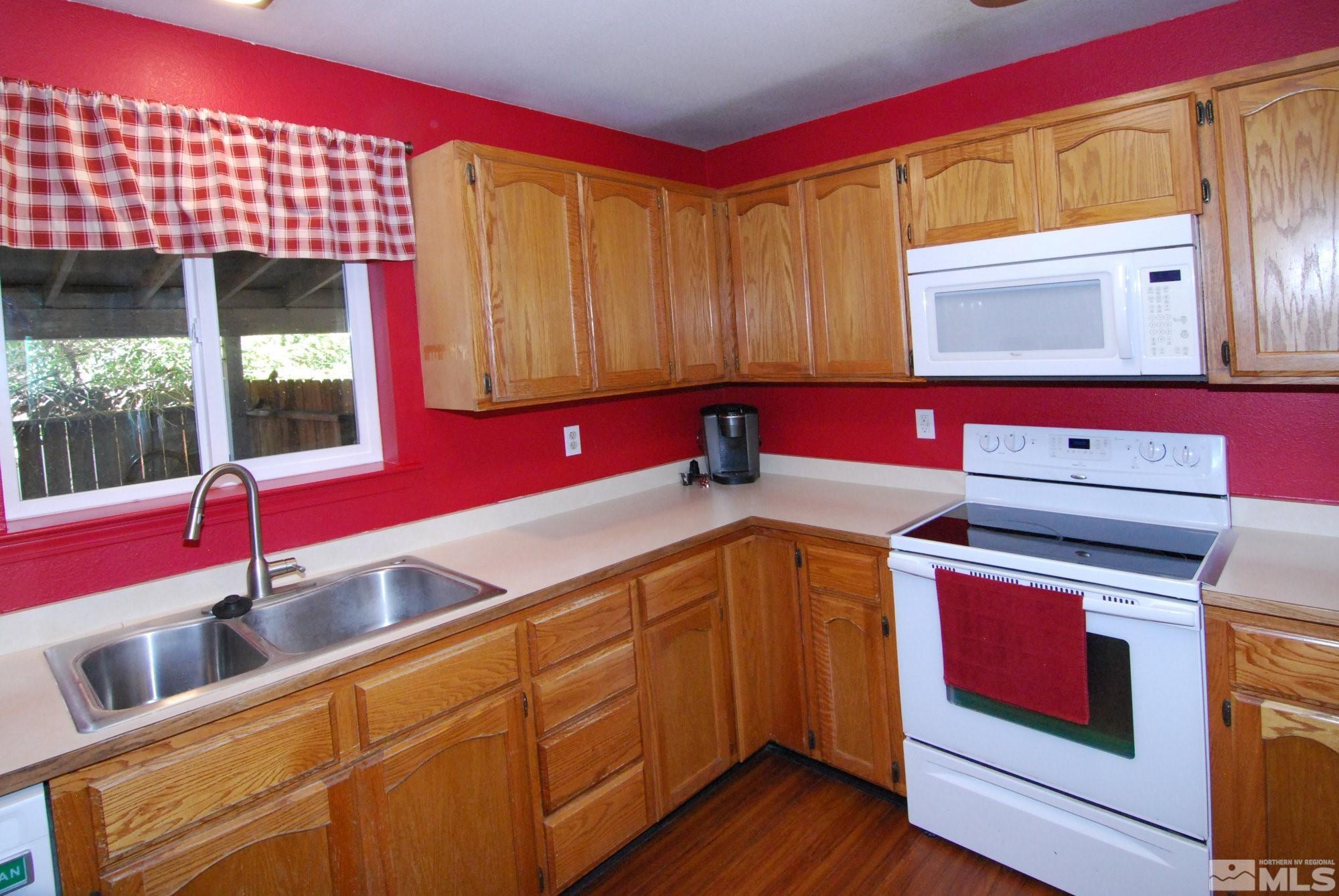 230 Whitaker Lane Fallon, NV 89406 - Photo 6 of 23 a kitchen with a stove a sink and a microwave