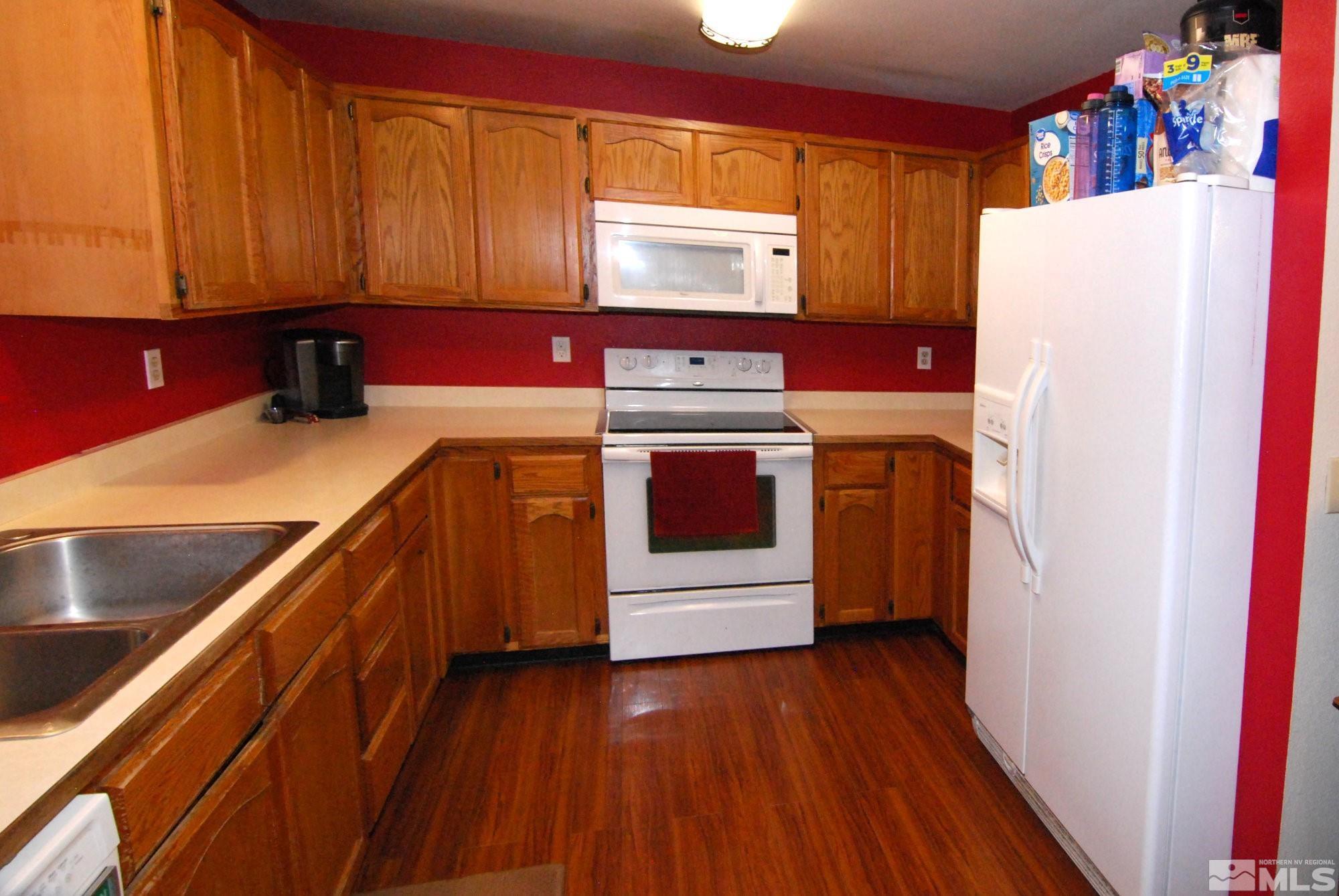 230 Whitaker Lane Fallon, NV 89406 - Photo 7 of 23 a kitchen with a refrigerator sink and cabinets