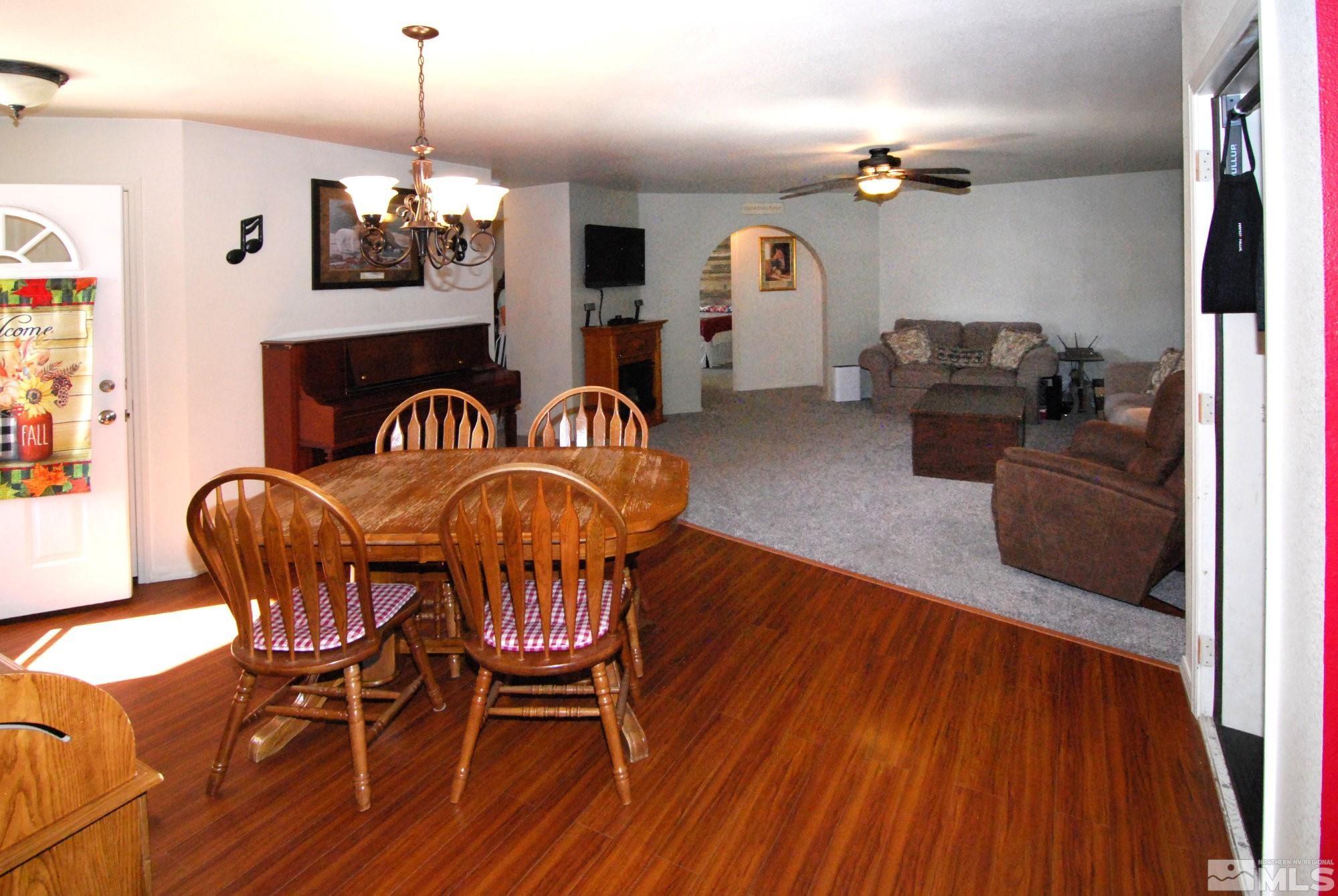 230 Whitaker Lane Fallon, NV 89406 - Photo 8 of 23 a view of a dining room with furniture wooden floor and chandelier