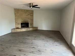 a view of empty room with a fireplace