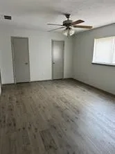 a view of an empty room with a ceiling fan