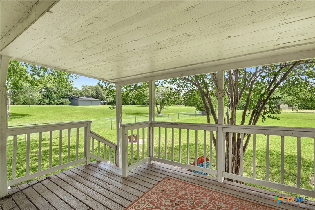 903 Summit Street Round Rock, TX 78664 - Photo 11 of 38 Back covered patio off the Flex room on the main floor at the back of the house. Great place to sit and relax and enjoy nature.