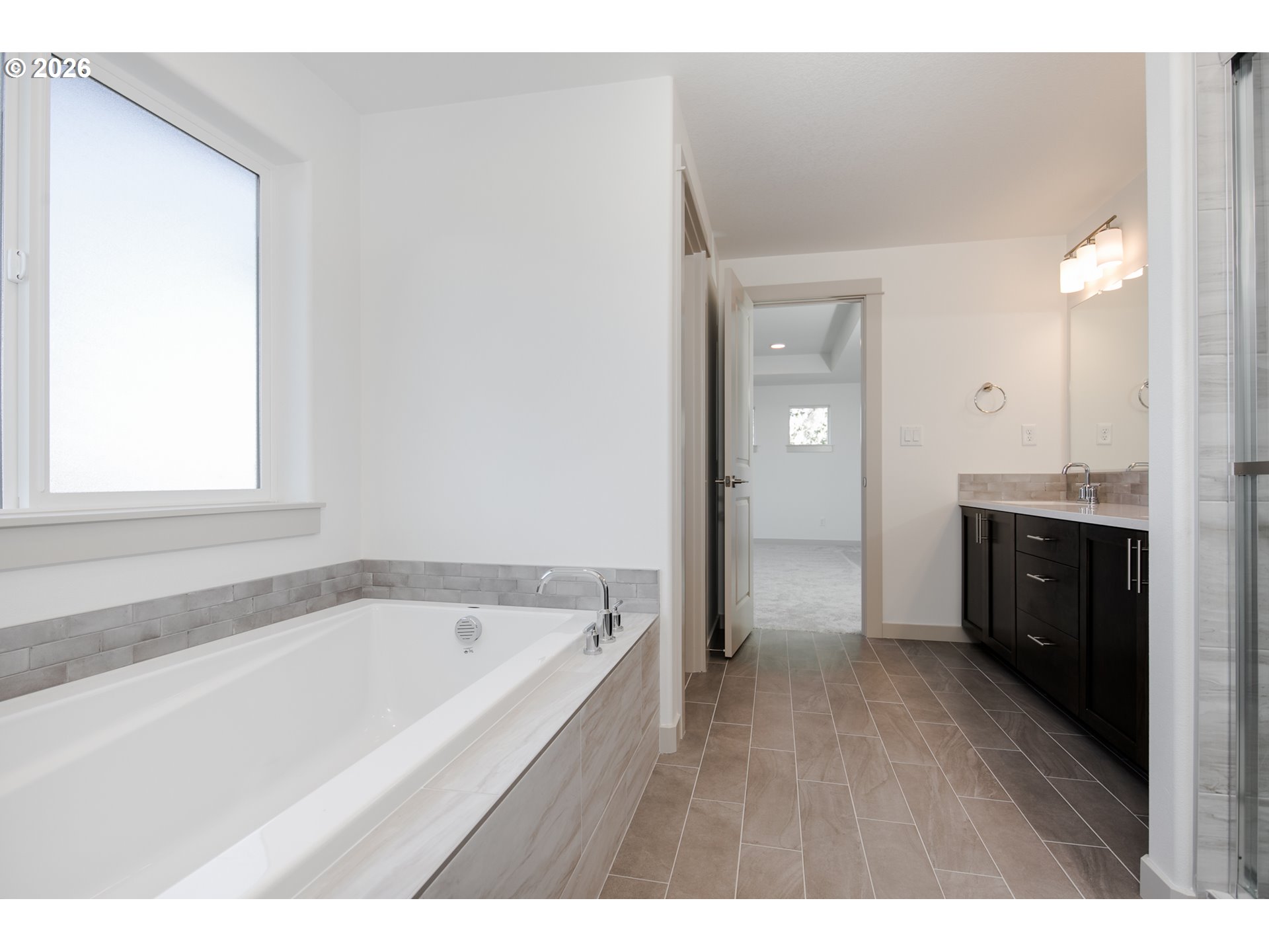 3714 Weldon Lane Eugene, OR 97403 - Photo 24 of 36 a bathroom with a bathtub a sink a vanity and a window