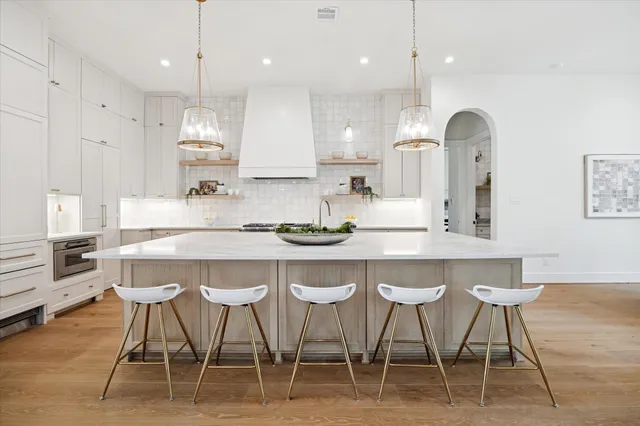 a living room with stainless steel appliances granite countertop furniture a large window with kitchen view