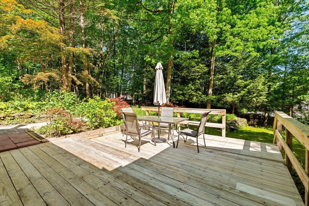 371 Longley Road Groton, MA 01450 - Photo 27 of 33 a view of a chairs and table on the wooden deck