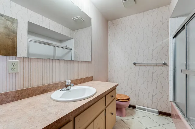 a bathroom with a sink toilet and shower
