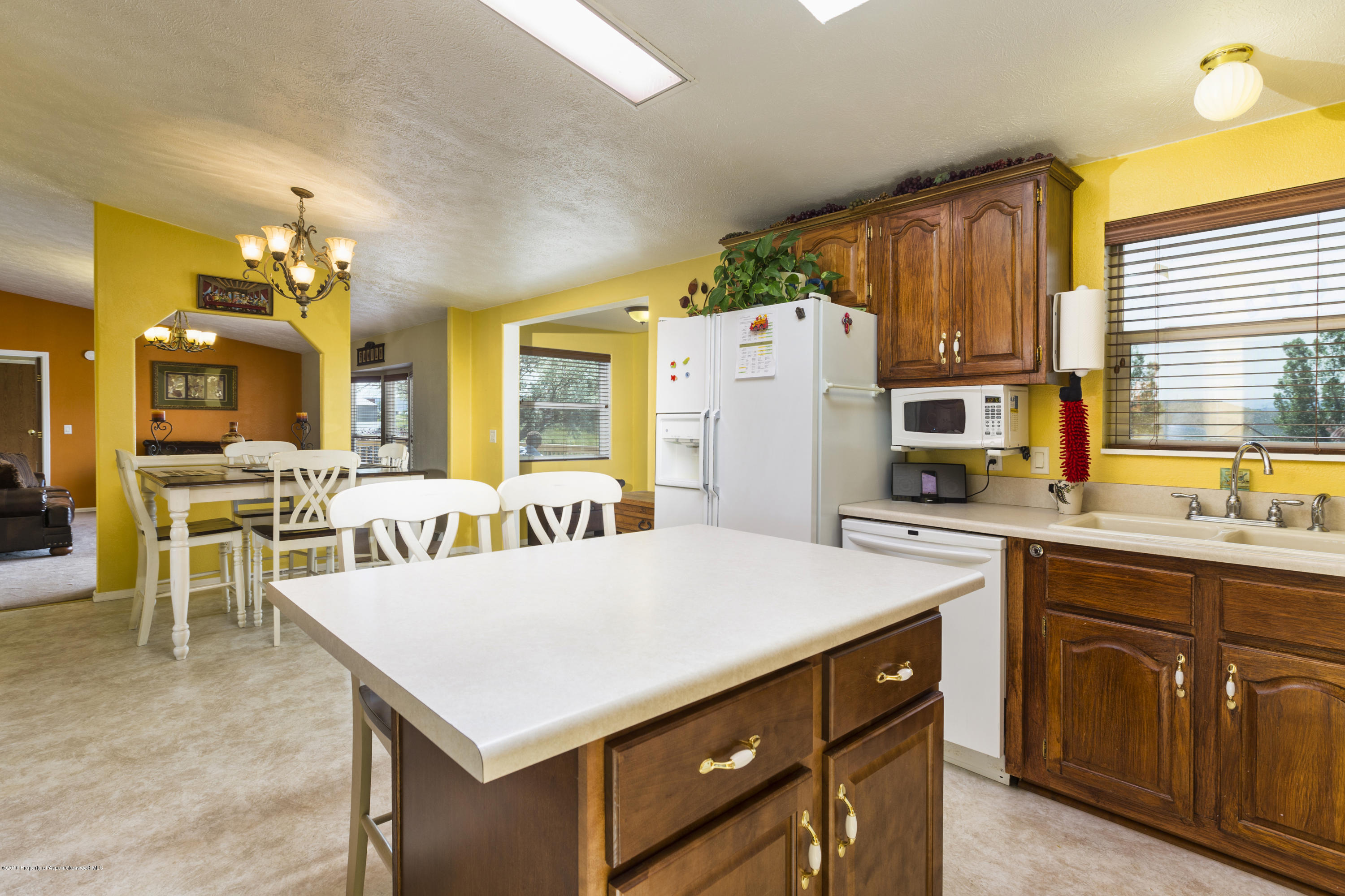 630 Lariat Road Silt, CO 81652 - Photo 11 of 21 a kitchen that has a lot of cabinets a sink and a refrigerator