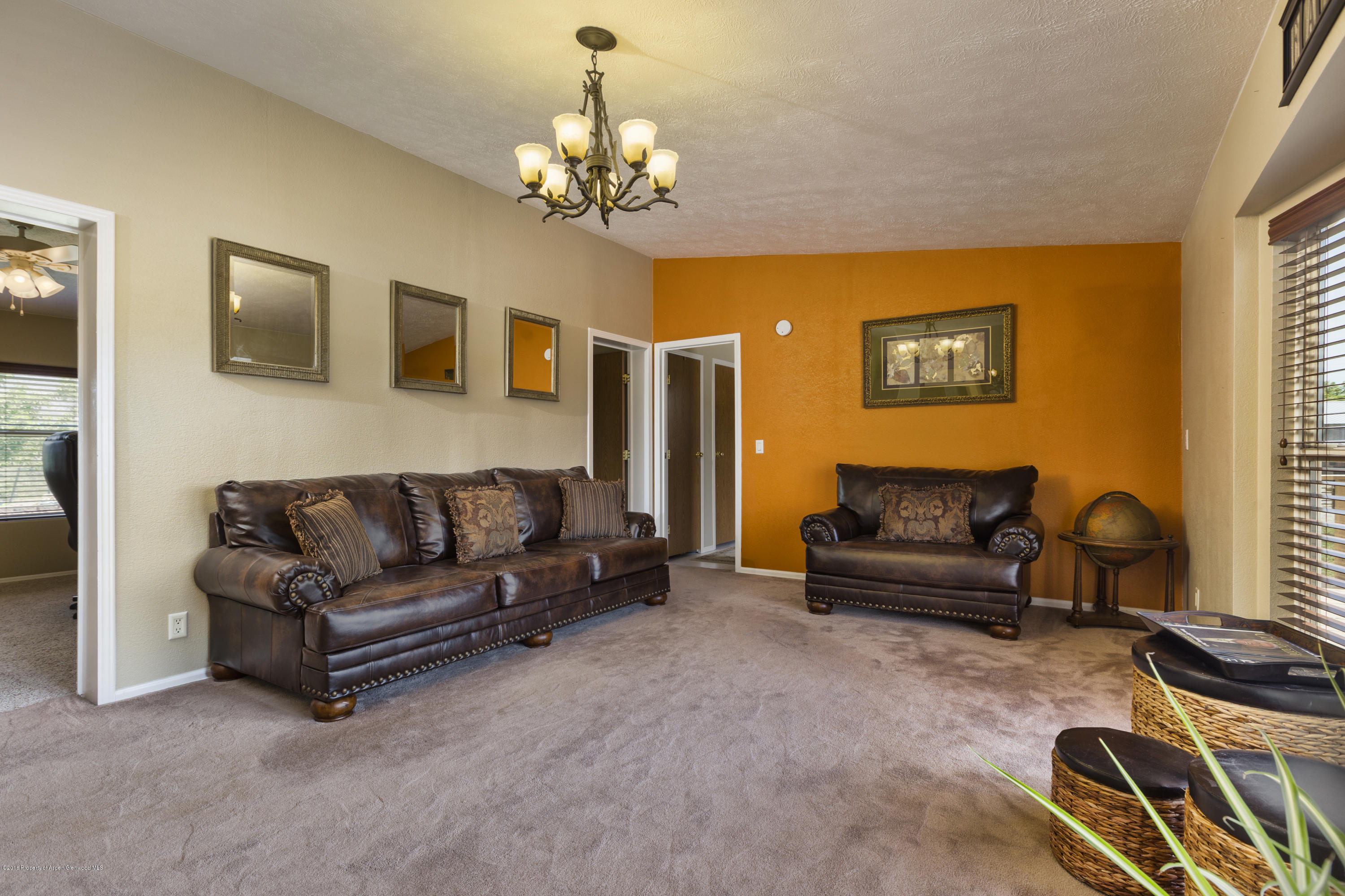 630 Lariat Road Silt, CO 81652 - Photo 17 of 21 a living room with furniture and a chandelier