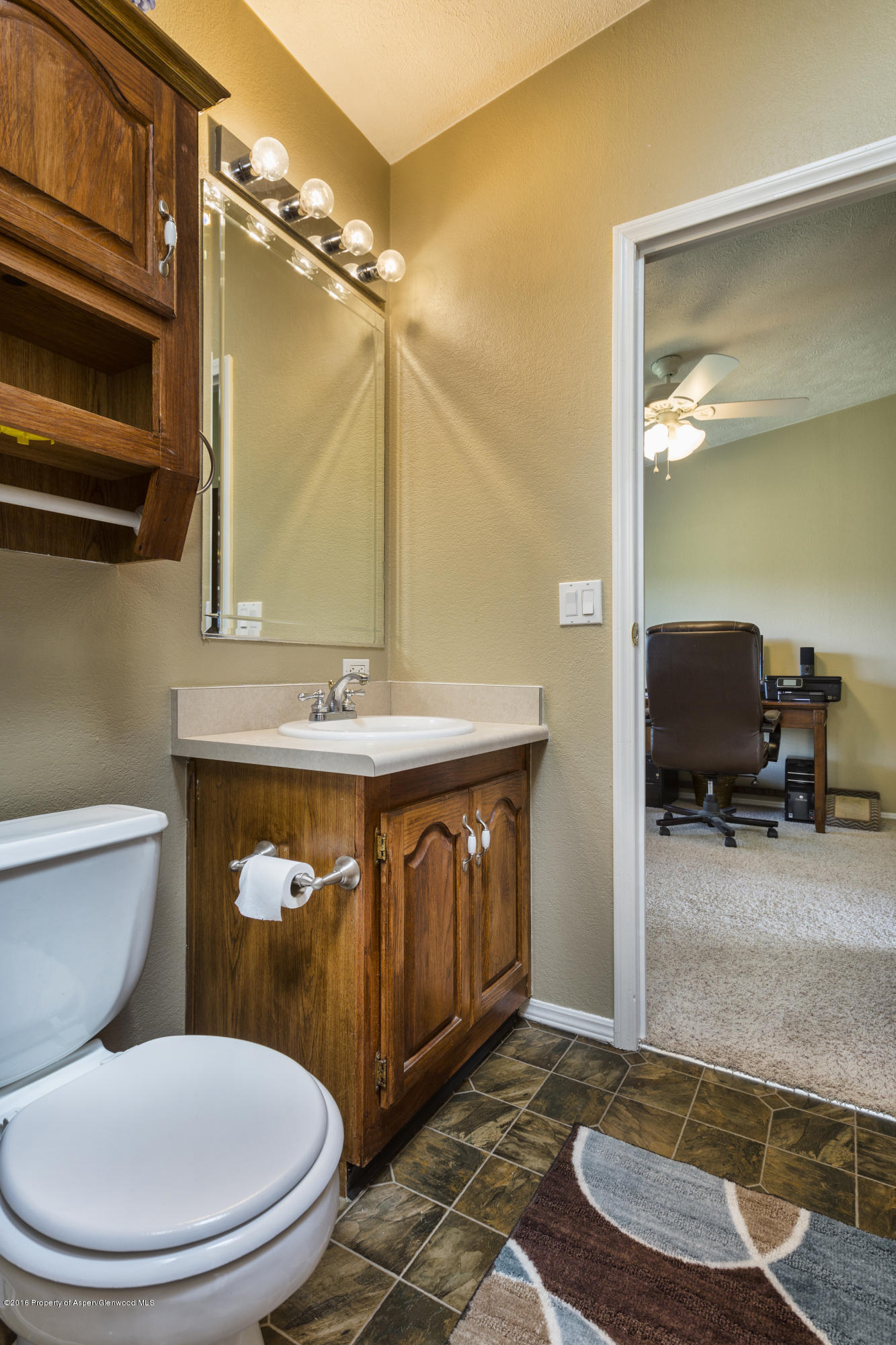 630 Lariat Road Silt, CO 81652 - Photo 18 of 21 a bathroom with a toilet a sink and mirror