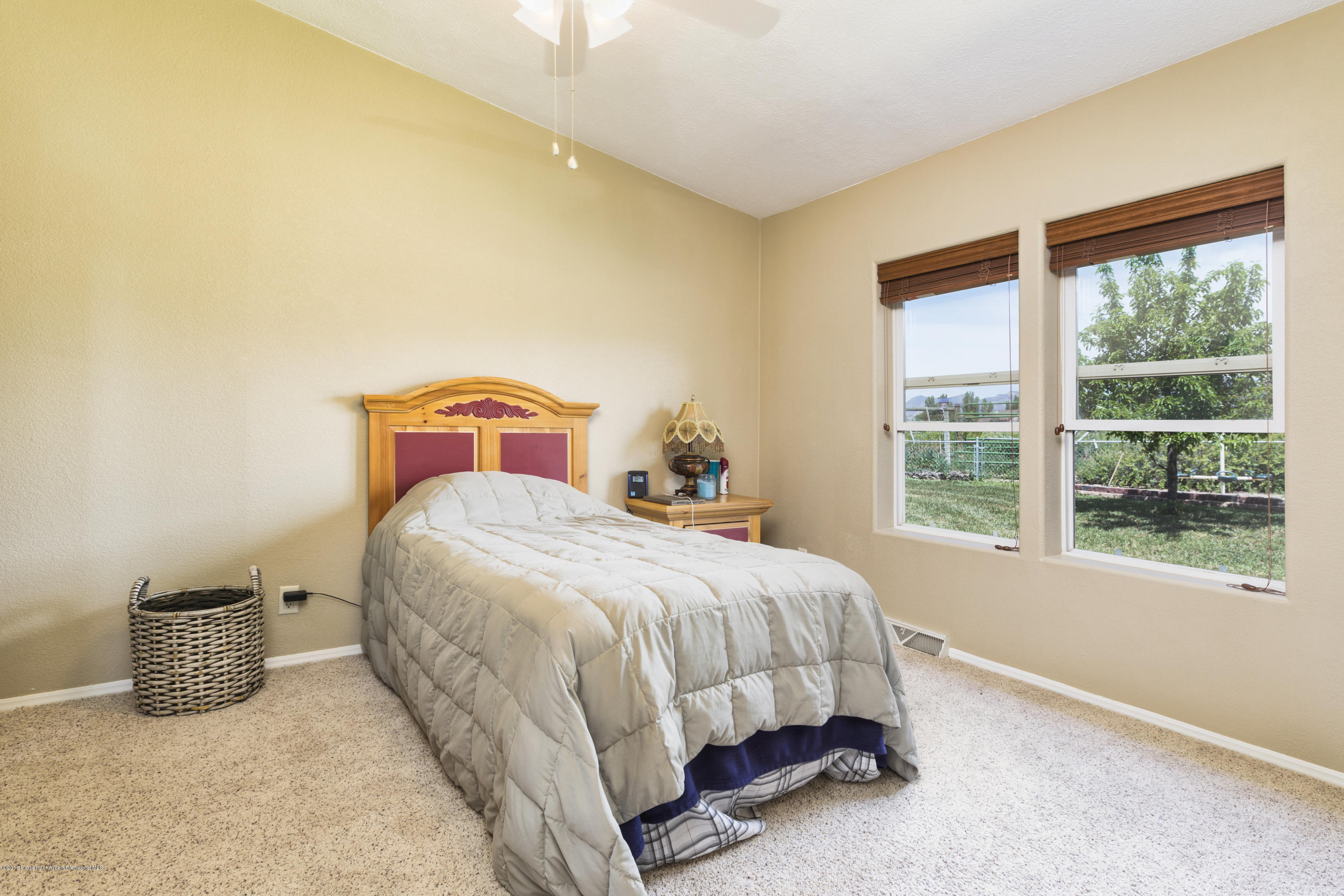 630 Lariat Road Silt, CO 81652 - Photo 20 of 21 a bedroom with a bed a table and a window