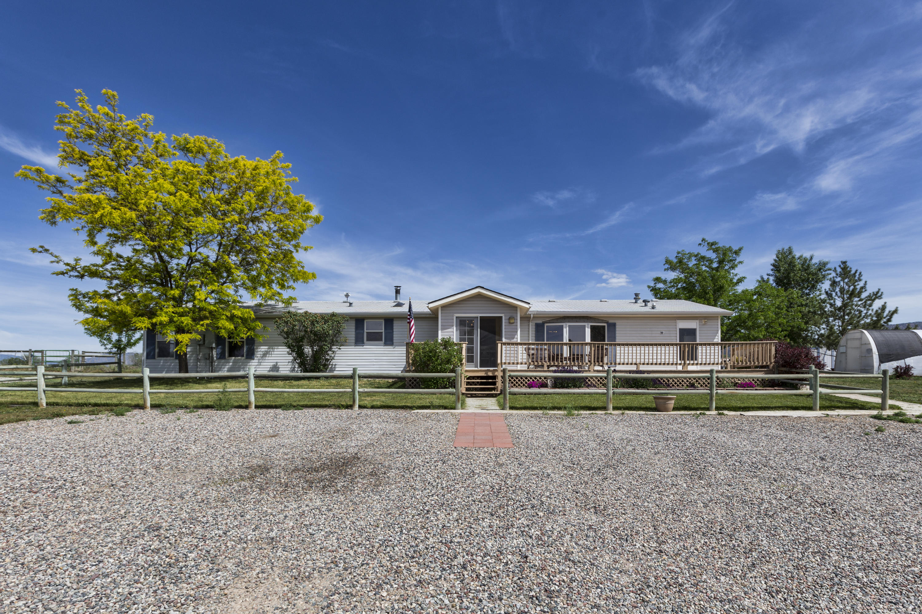 630 Lariat Road Silt, CO 81652 - Photo 4 of 21 a view of a house with a big yard and plants