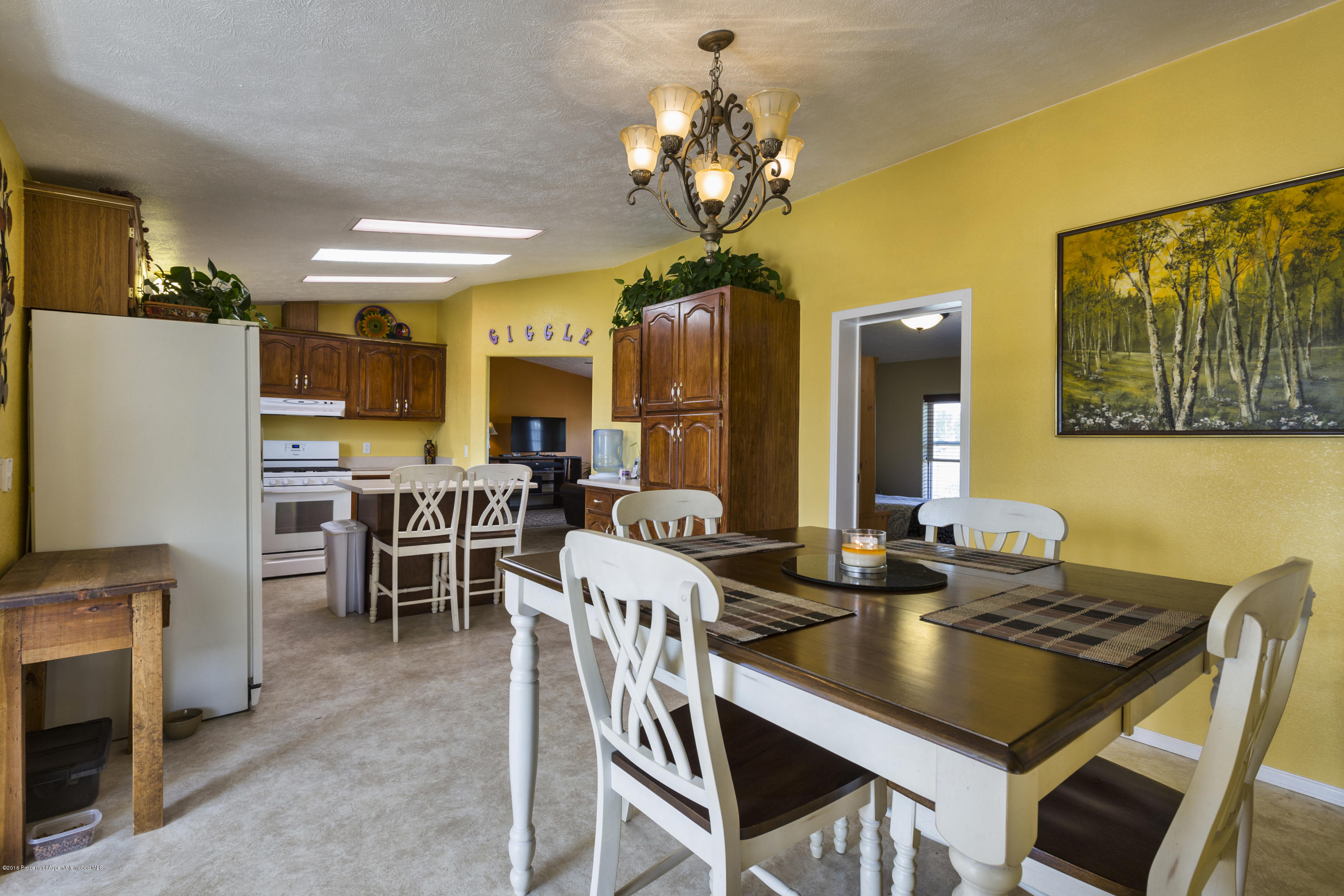 630 Lariat Road Silt, CO 81652 - Photo 10 of 21 a view of a dining room with furniture and chandelier