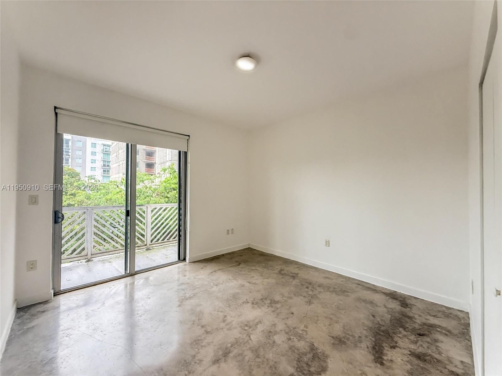 771 Northwest 1st Street, Unit 302 Miami, FL 33128 - Photo 11 of 18 a view of a room with sliding glass door