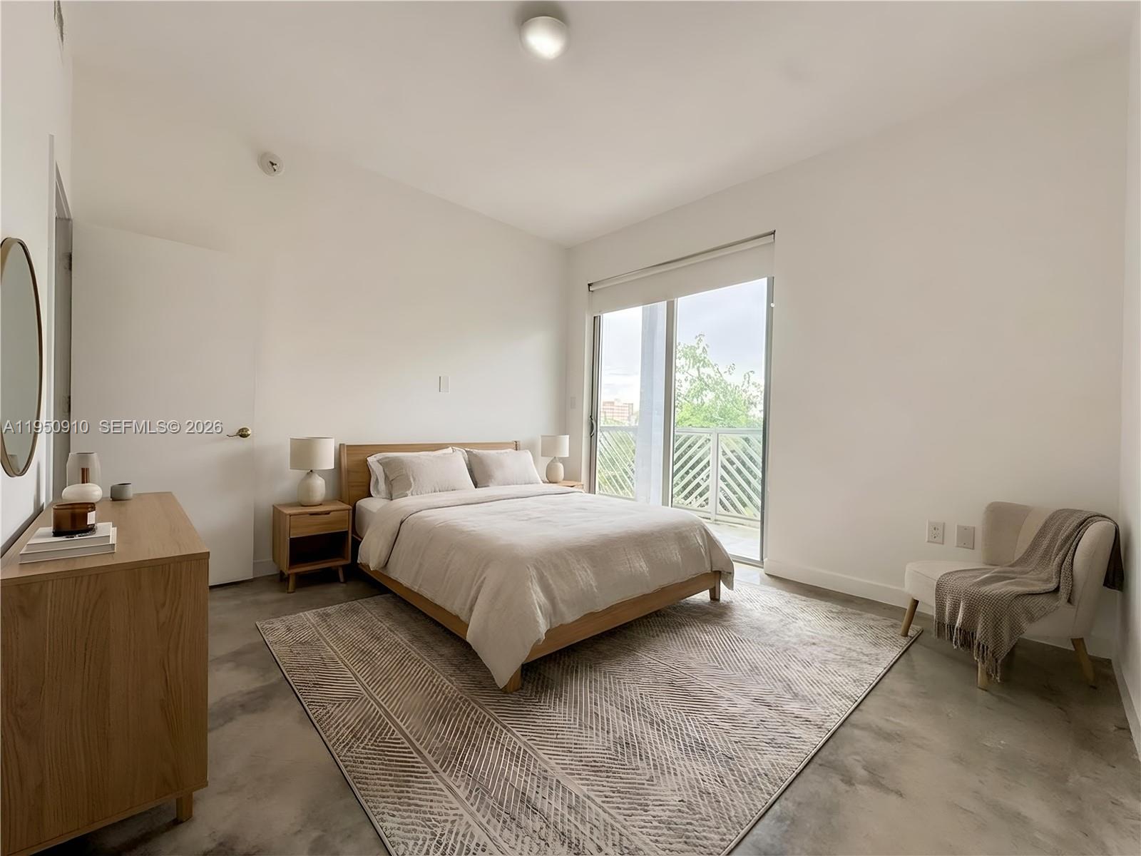 771 Northwest 1st Street, Unit 302 Miami, FL 33128 - Photo 12 of 18 a bedroom with a bed and a chair