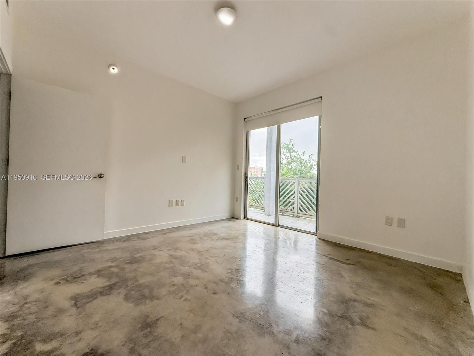 771 Northwest 1st Street, Unit 302 Miami, FL 33128 - Photo 13 of 18 an empty room with wooden floor and windows