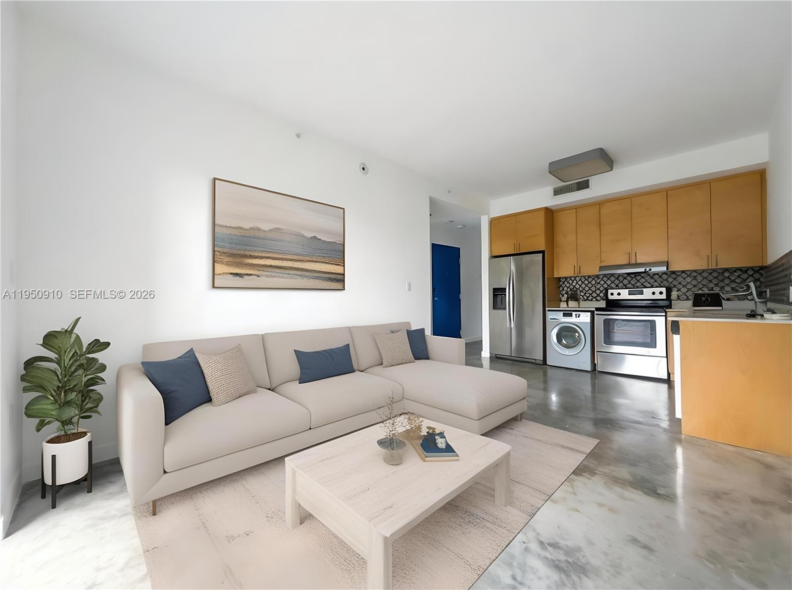 771 Northwest 1st Street, Unit 302 Miami, FL 33128 - Photo 2 of 18 a living room with furniture and kitchen view