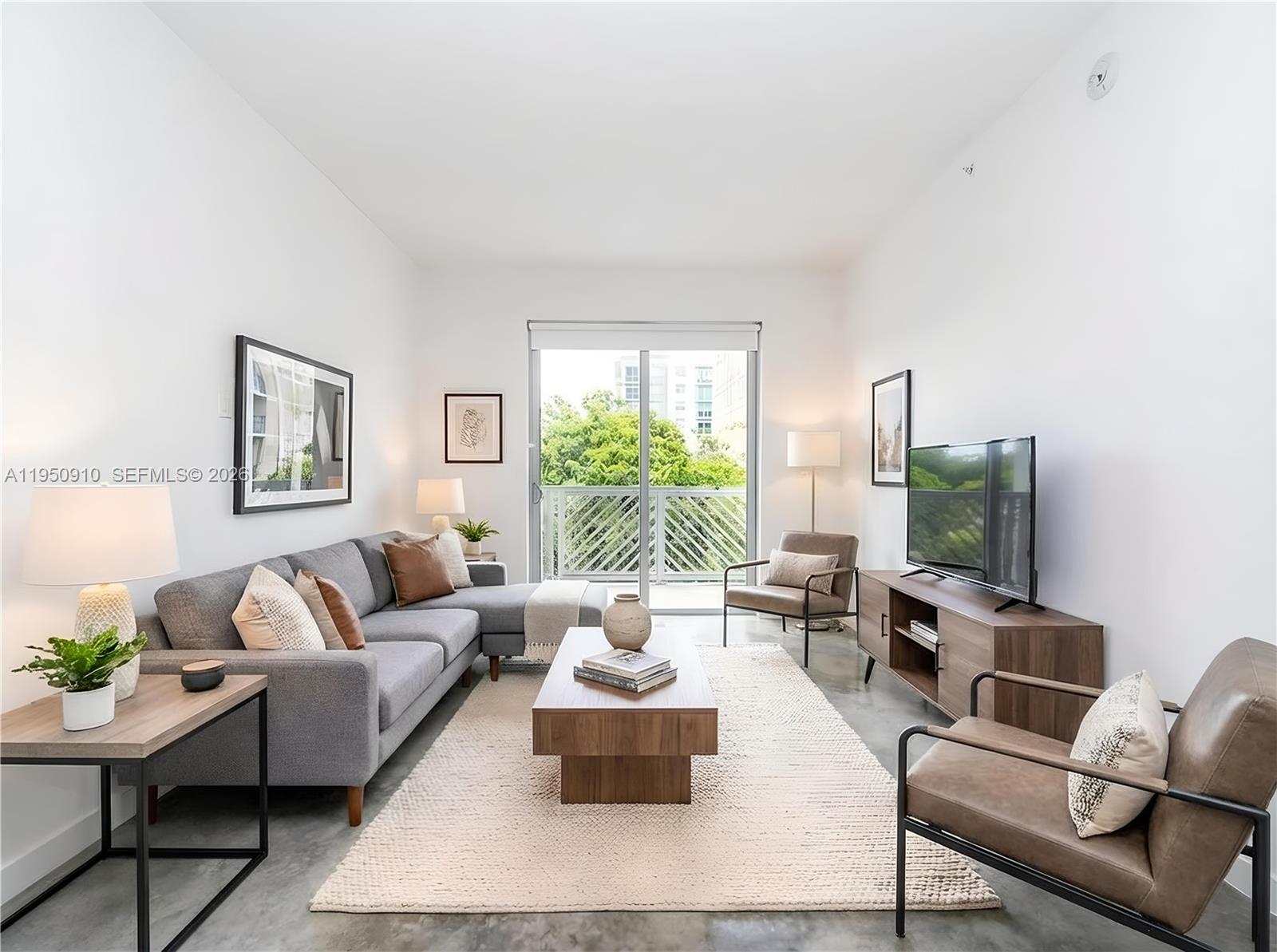 771 Northwest 1st Street, Unit 302 Miami, FL 33128 - Photo 6 of 18 a living room with furniture and a large window
