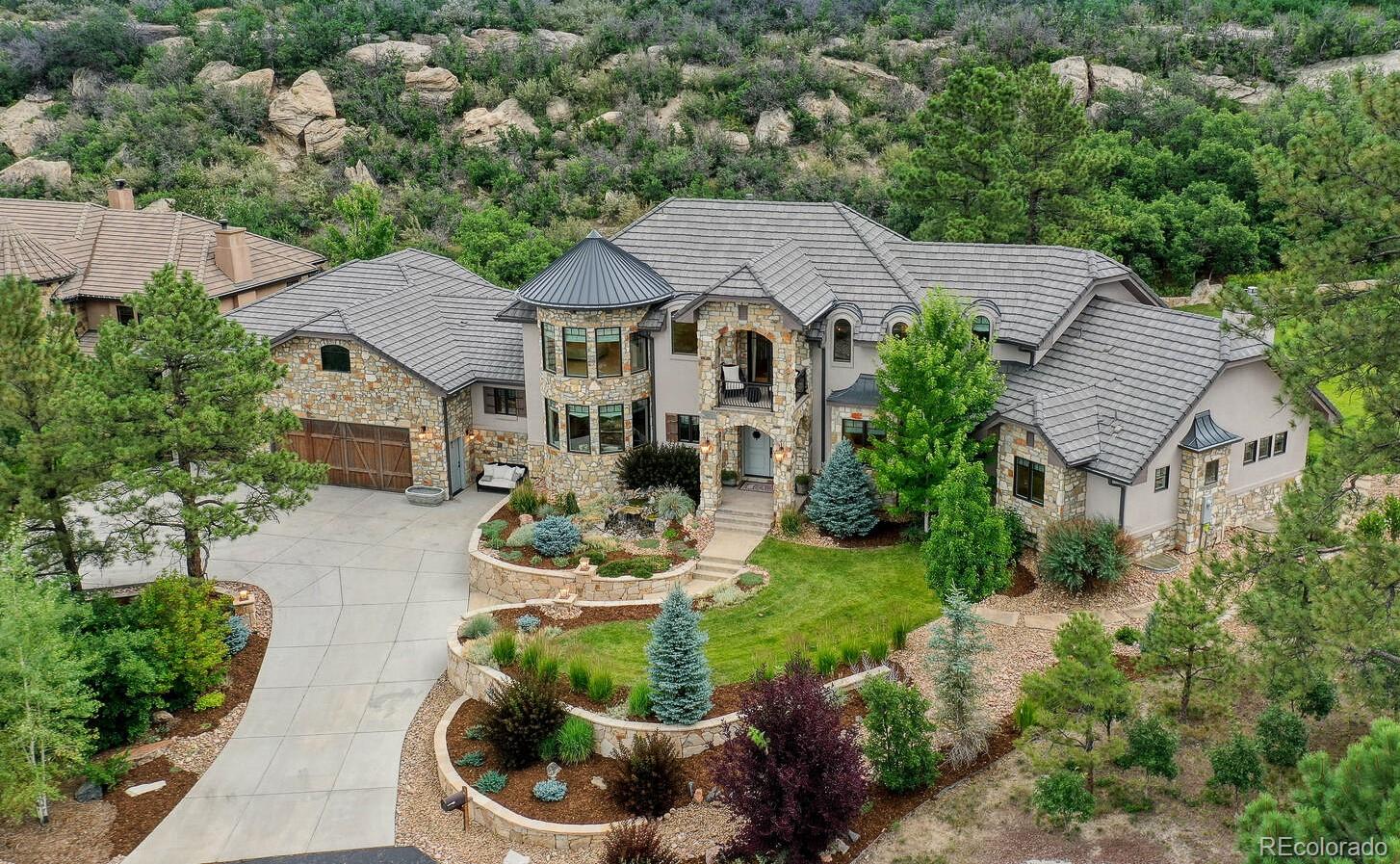 an aerial view of a house with garden space and street view