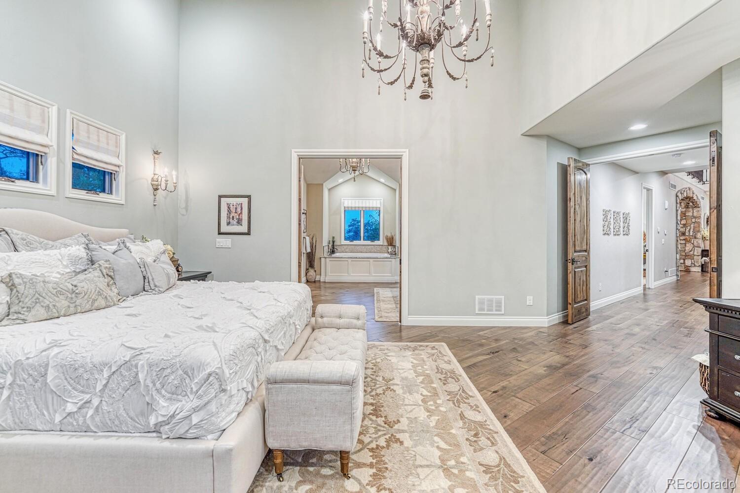 2236 Beechnut Place Castle Rock, CO 80108 - Photo 20 of 40 a bedroom with a bed and a chandelier