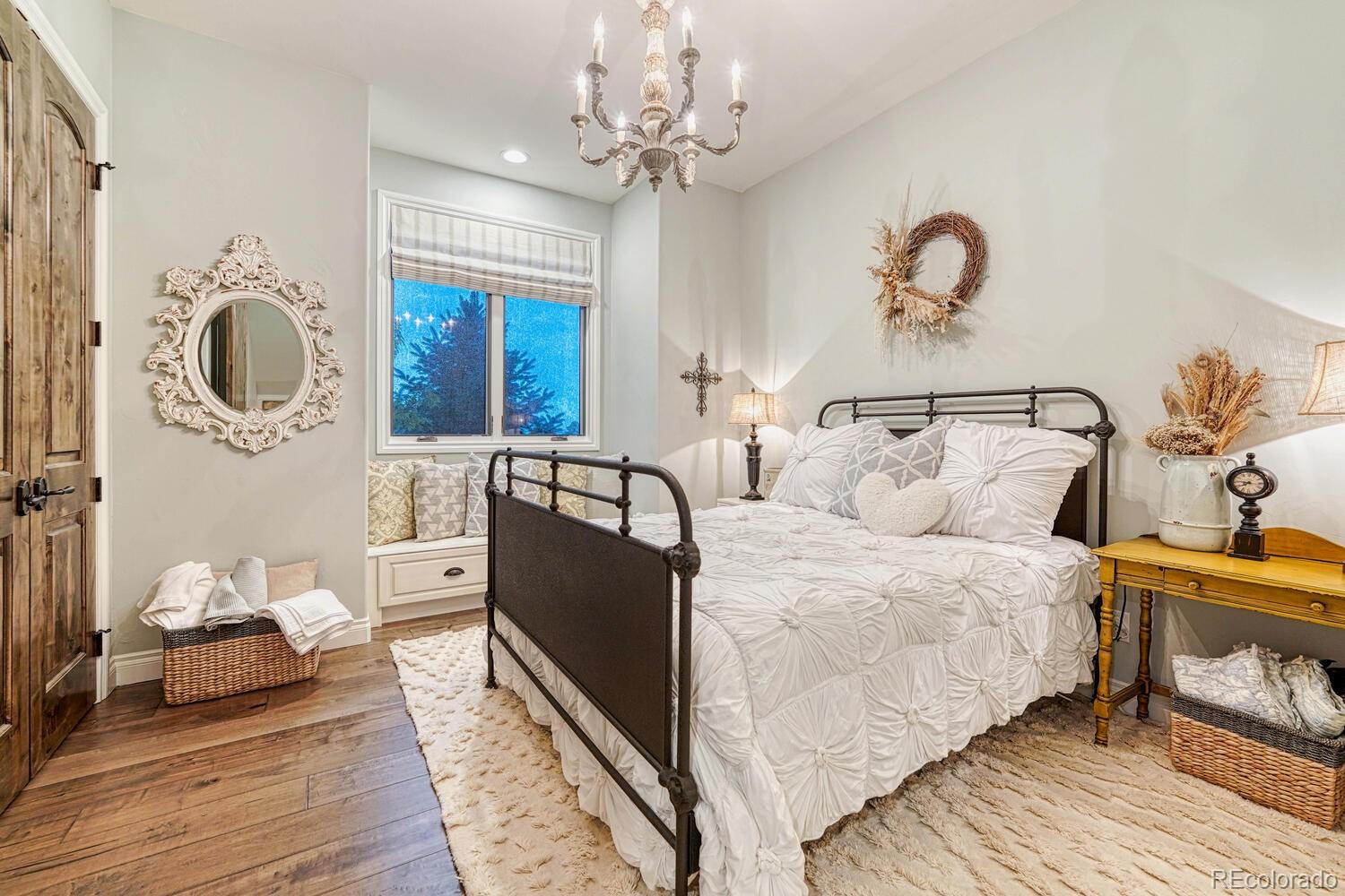 2236 Beechnut Place Castle Rock, CO 80108 - Photo 23 of 40 a bed room with a bed and a chandelier