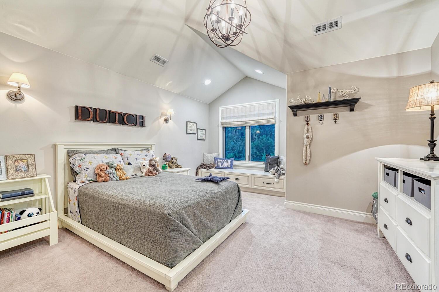 2236 Beechnut Place Castle Rock, CO 80108 - Photo 31 of 40 a bedroom with a bed and a chandelier