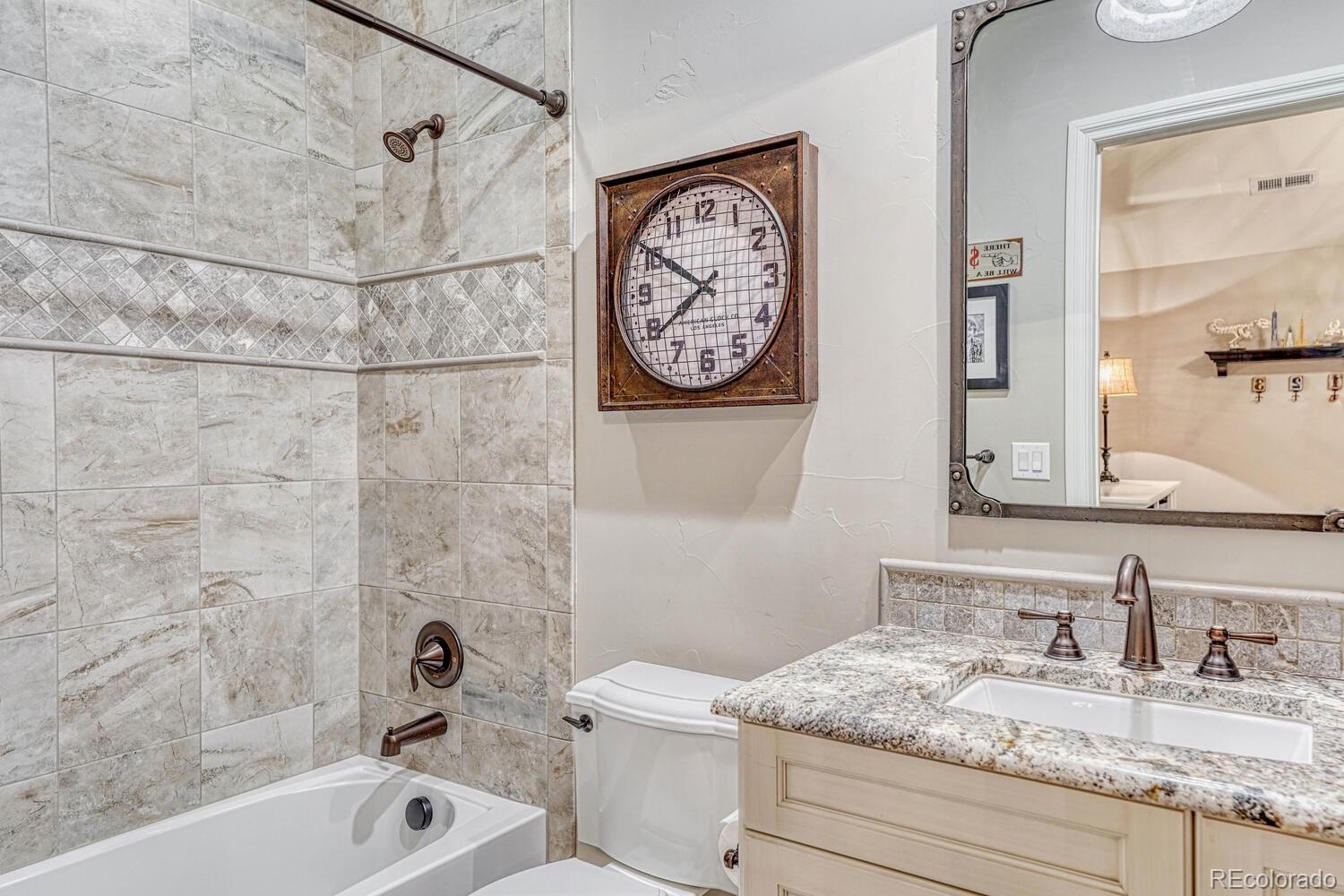 2236 Beechnut Place Castle Rock, CO 80108 - Photo 32 of 40 a bathroom with a granite countertop sink mirror vanity and bathtub