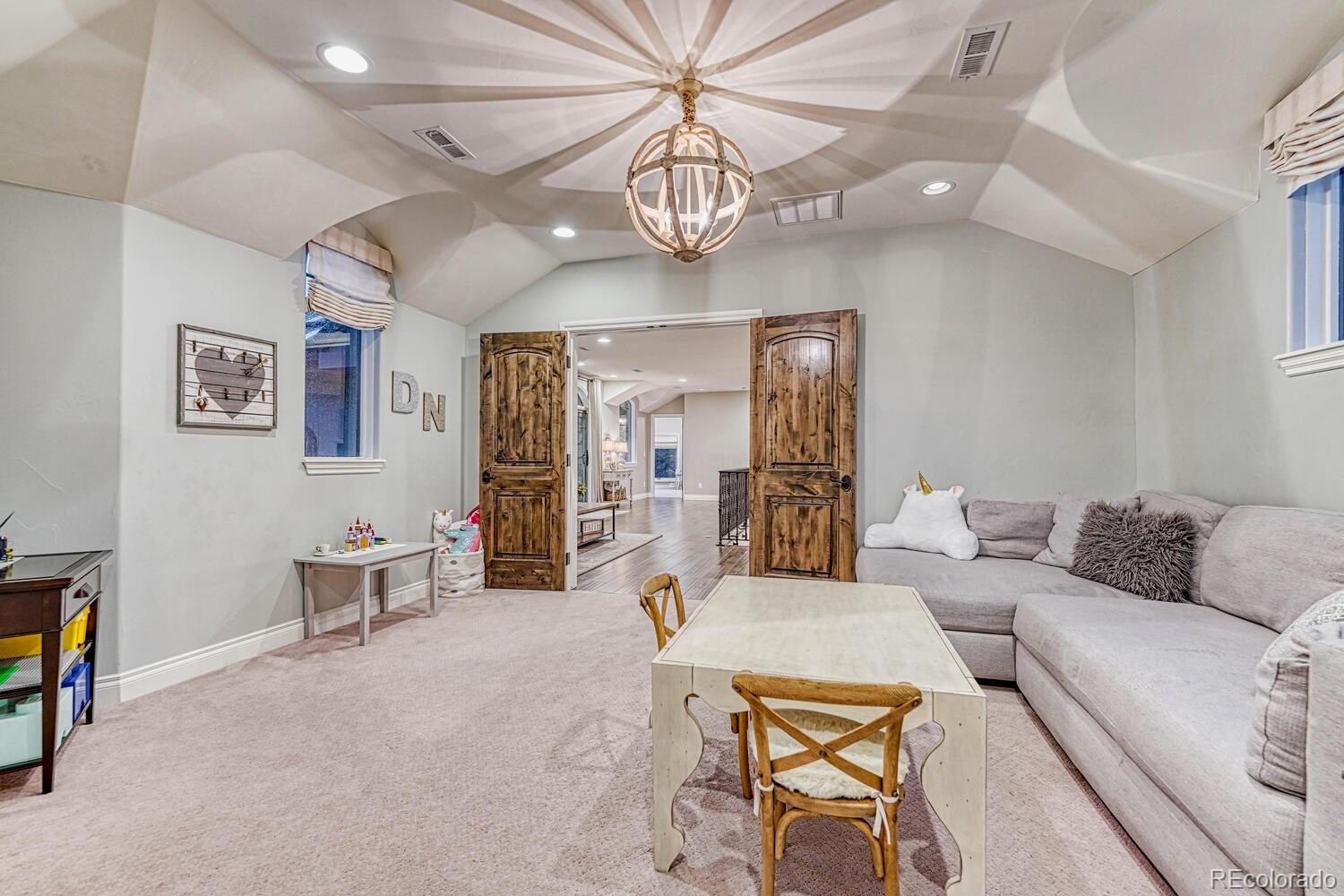 2236 Beechnut Place Castle Rock, CO 80108 - Photo 33 of 40 a living room with furniture a chandelier and a dining table