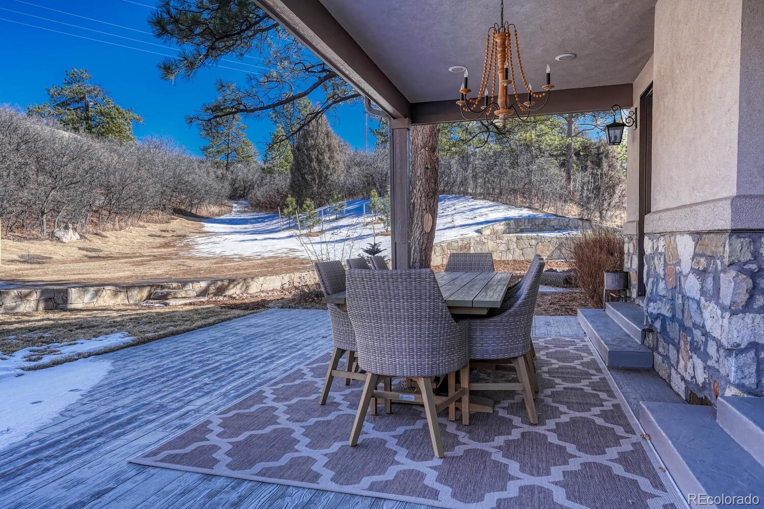 2236 Beechnut Place Castle Rock, CO 80108 - Photo 38 of 40 a view of a patio with table and chairs and wooden floor