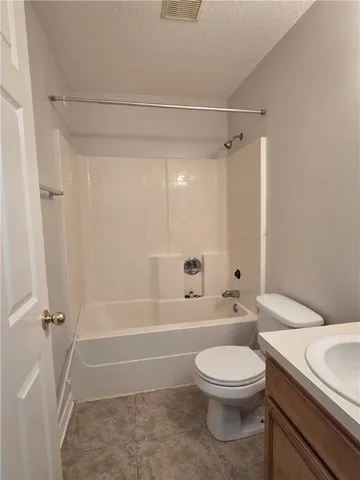 a bathroom with a toilet a sink and shower