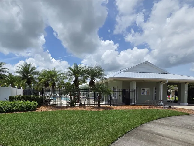 a view of a house with garden and a tree