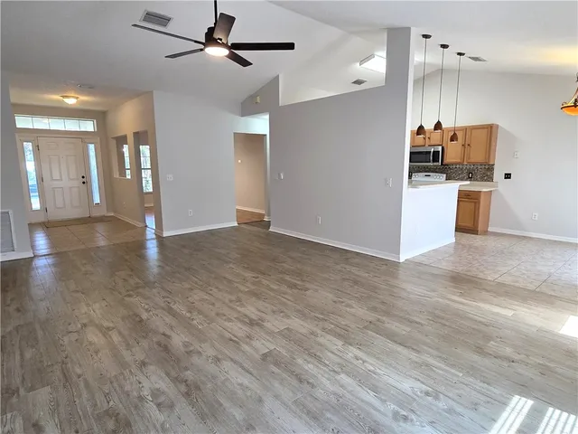 a view of kitchen with a sink and a refrigerator