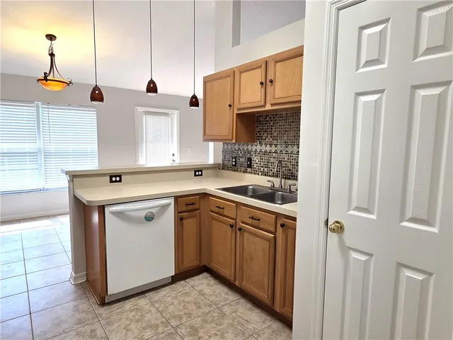 a kitchen with a sink cabinets and window